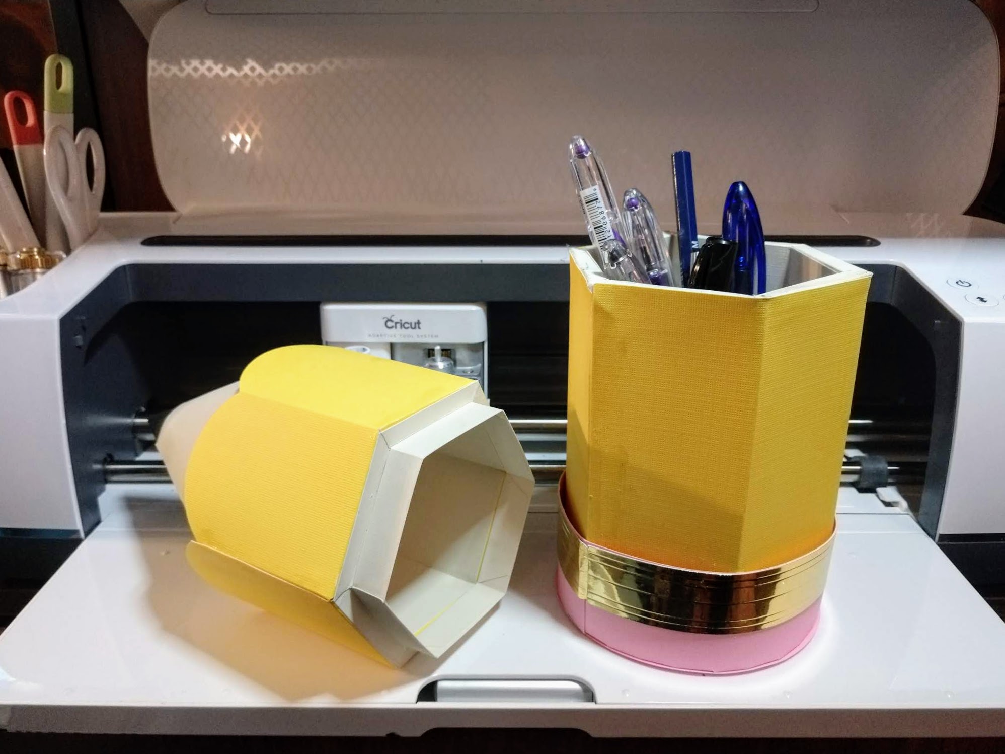 Pencil box open with pens inside